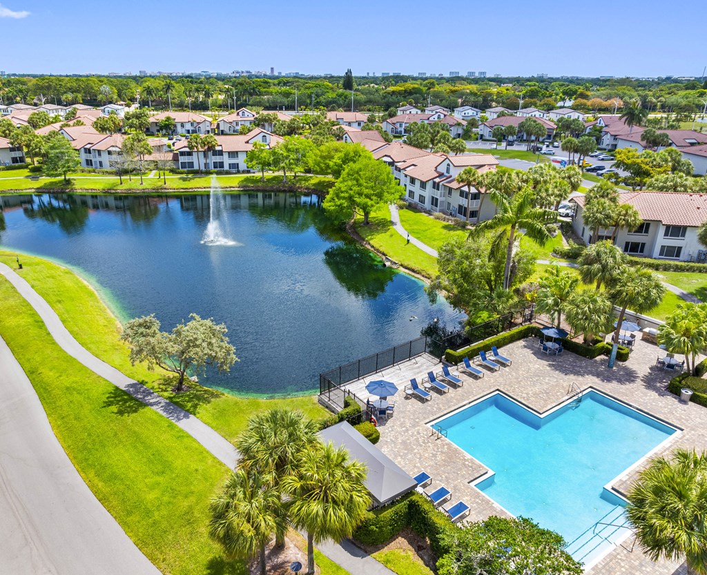 A beautiful aerial view of a residential area with a swimming pool and a fountain.